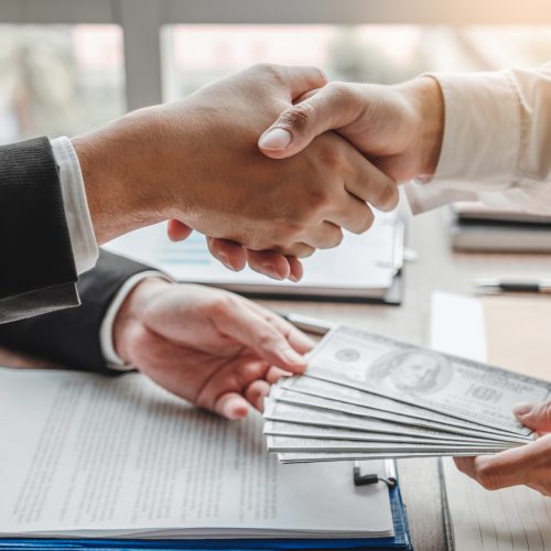 [fpdl.in]_businessman-shaking-hands-giving-dollar-bills-corruption-bribery-business-manager-deal-contract_45041-198_full