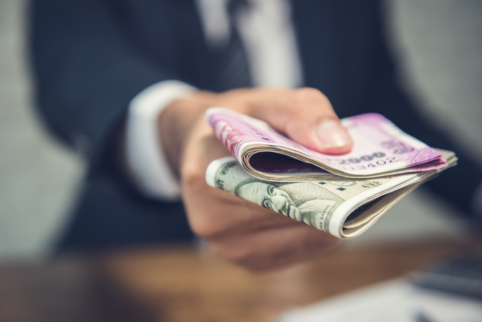[fpdl.in]_businessman-giving-money-form-indian-rupees-currency_8087-1448_full
