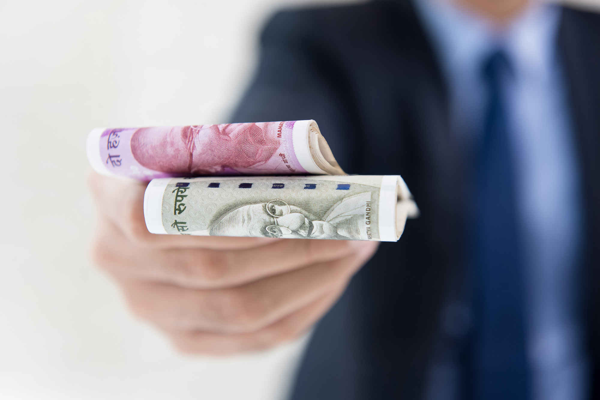 [fpdl.in]_businessman-giving-money-form-indian-rupees-f_8087-2744_full
