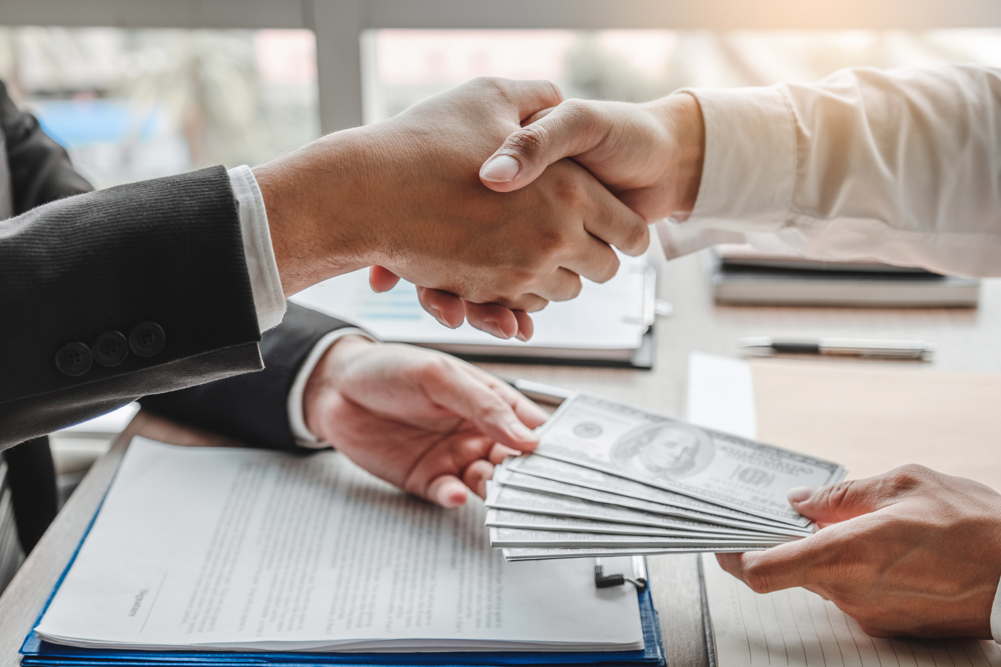 [fpdl.in]_businessman-shaking-hands-giving-dollar-bills-corruption-bribery-business-manager-deal-contract_45041-198_full
