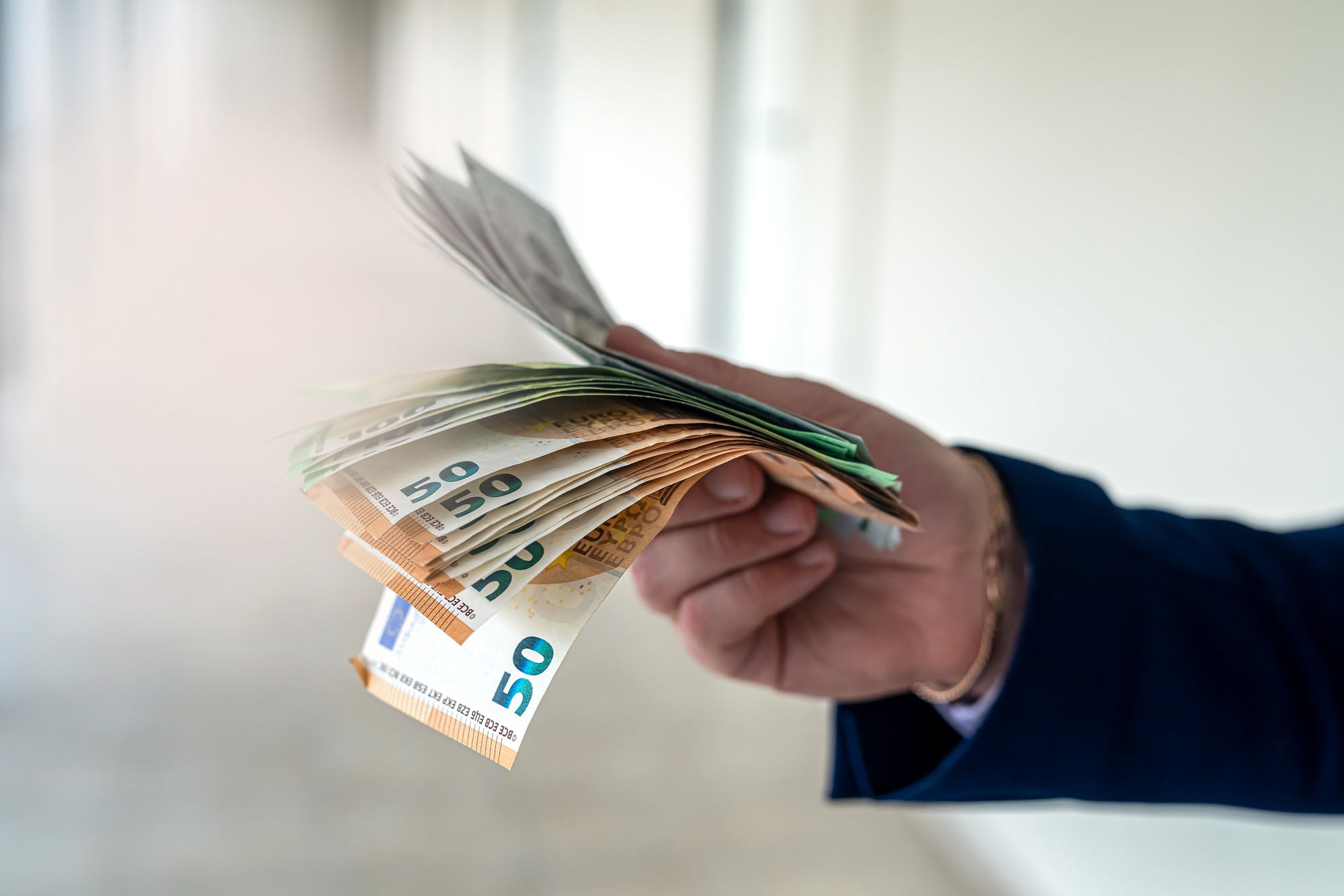 [fpdl.in]_male-hand-giving-euro-banknotes-office-centr-finance-concept_359031-18800_full